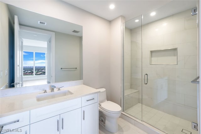 bathroom featuring vanity, a shower with shower door, toilet, and tile patterned flooring