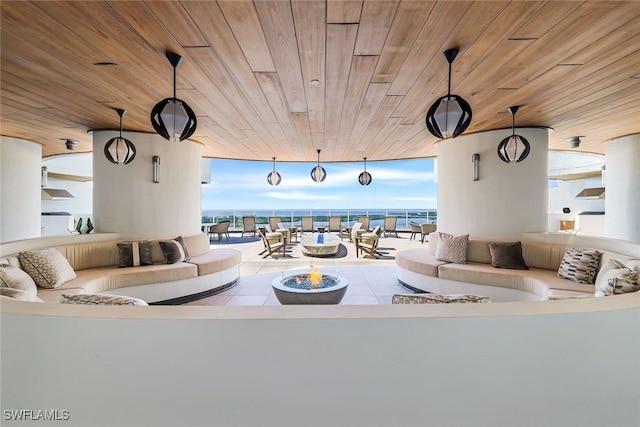 living room with wood ceiling and a water view