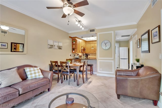 living room featuring ceiling fan, crown molding, and light tile patterned flooring