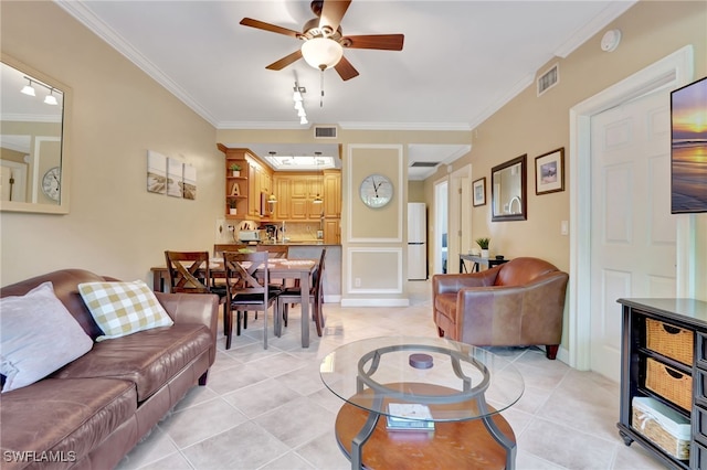 living room with light tile patterned floors and ornamental molding