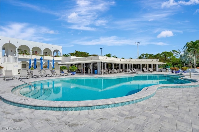 3323 Olympic Dr Unit 715, Naples, FL 34105 - community pool featuring a patio