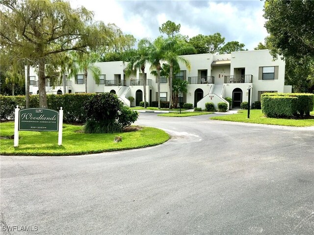 3323 Olympic Dr Unit 715, Naples, FL 34105 - view of asphalt street with stairway and a residential view