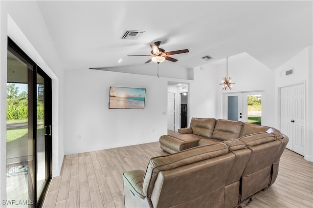 living room with light wood-type flooring, lofted ceiling, ceiling fan, and french doors