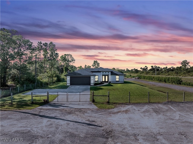 view of front of property with a garage and a yard