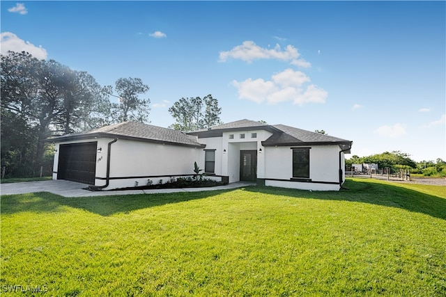 view of front facade with a garage and a front lawn