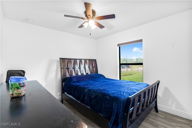 bedroom with ceiling fan and hardwood / wood-style flooring