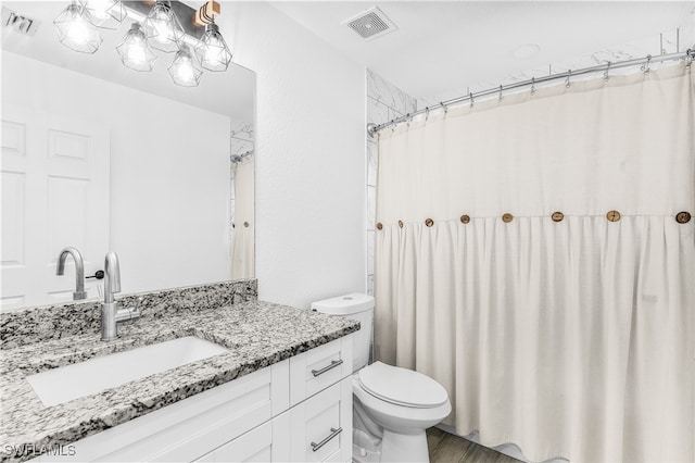 bathroom featuring a shower with shower curtain, hardwood / wood-style flooring, vanity, and toilet