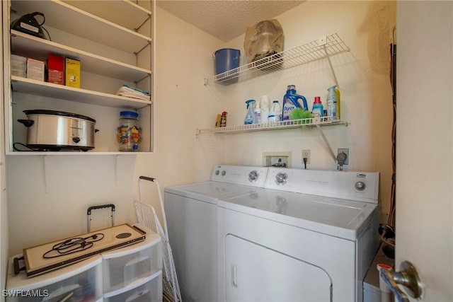 washroom with separate washer and dryer and a textured ceiling