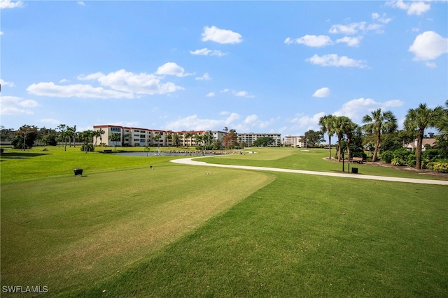 view of property's community with a lawn