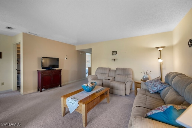 carpeted living room with a textured ceiling