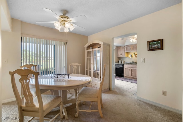 dining space with light colored carpet, sink, a textured ceiling, and ceiling fan