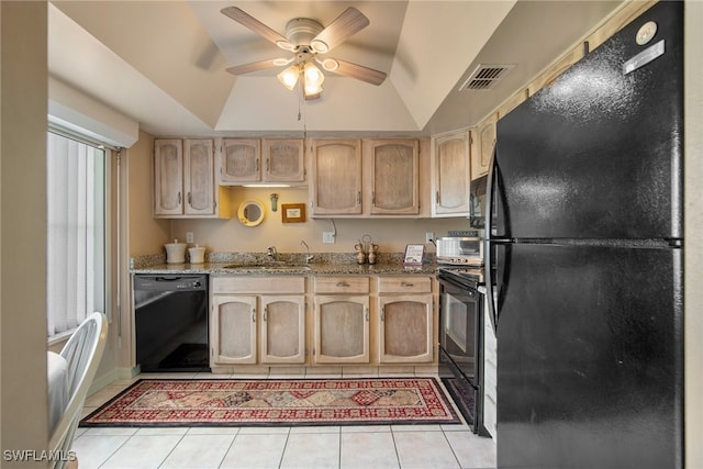 kitchen with light tile patterned flooring, light brown cabinetry, vaulted ceiling, sink, and black appliances