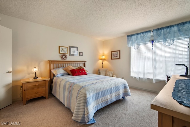 bedroom featuring light colored carpet and a textured ceiling