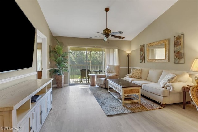 living room with light wood-type flooring, ceiling fan, and lofted ceiling