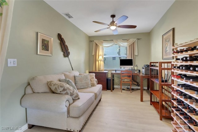 office space with light wood-type flooring and ceiling fan