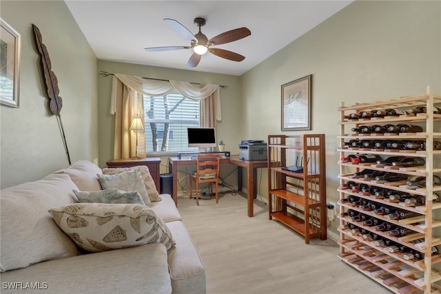 home office with ceiling fan and light wood-type flooring