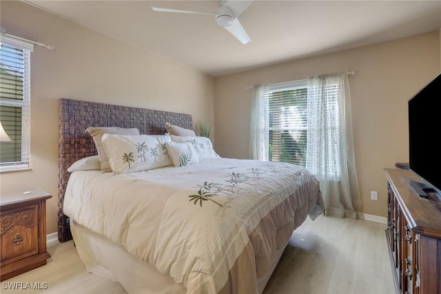 bedroom featuring multiple windows, ceiling fan, and light hardwood / wood-style floors