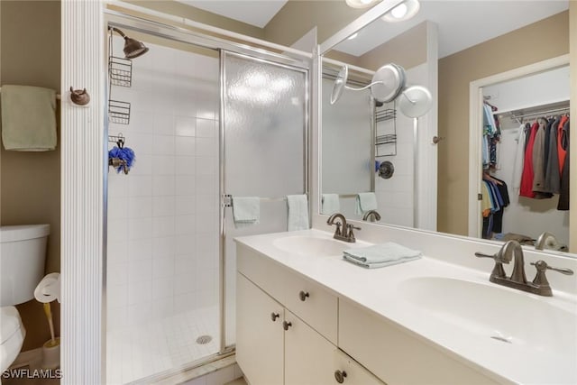 bathroom featuring vanity, toilet, and walk in shower