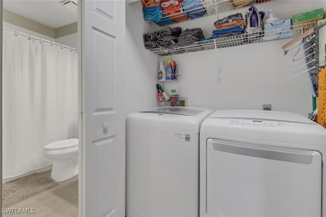 laundry area featuring light hardwood / wood-style flooring and independent washer and dryer