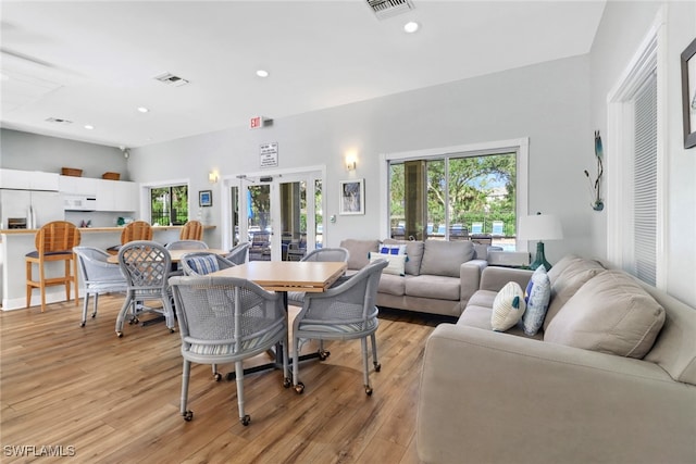 dining room with french doors and light hardwood / wood-style floors