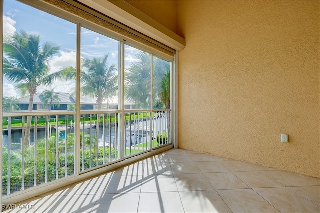 unfurnished sunroom with a water view