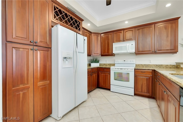 kitchen featuring light stone counters, crown molding, white appliances, light tile patterned floors, and a tray ceiling