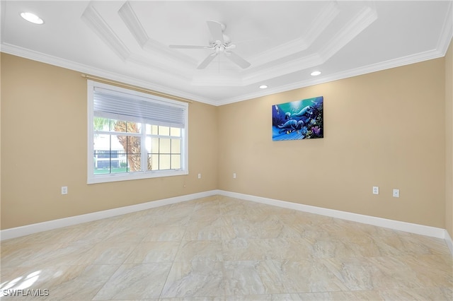 unfurnished room featuring a raised ceiling, ceiling fan, and crown molding