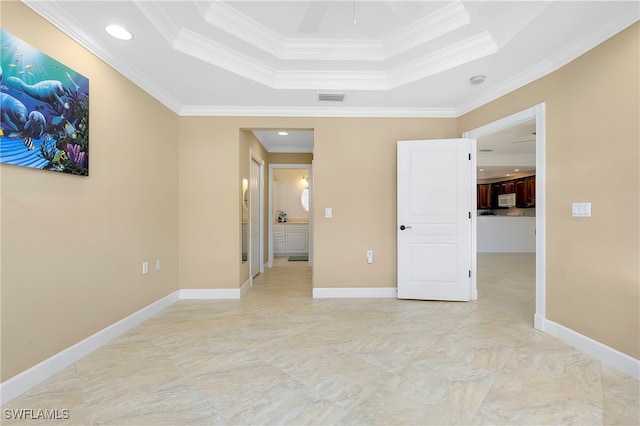 unfurnished bedroom featuring crown molding and a tray ceiling