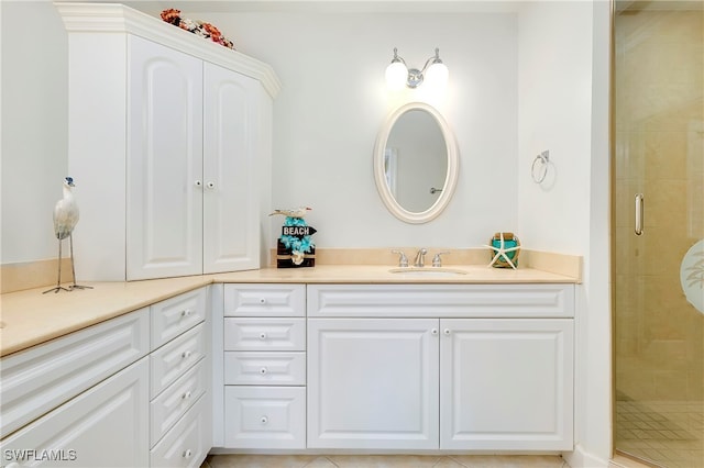 bathroom featuring vanity, tile patterned flooring, and a shower with door