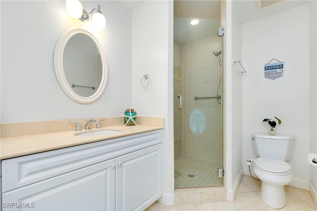 bathroom featuring toilet, vanity, tile patterned floors, and a shower with door