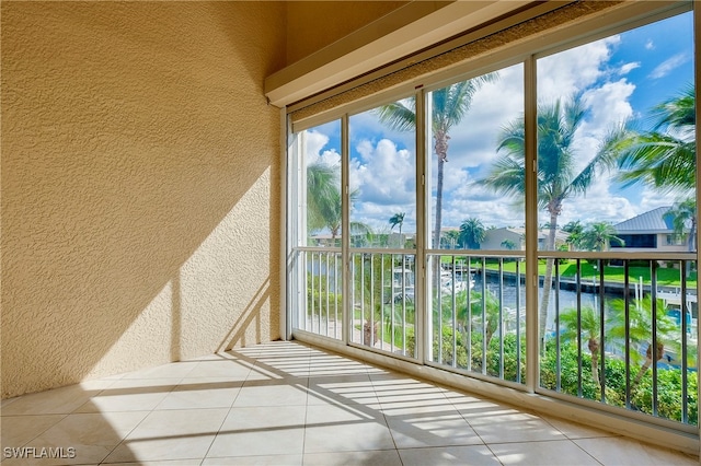 unfurnished sunroom with a water view