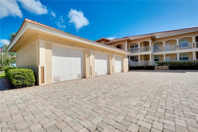 exterior space featuring a garage and a balcony