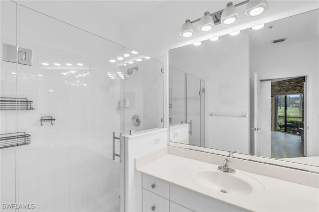 bathroom featuring vanity and a shower with shower door