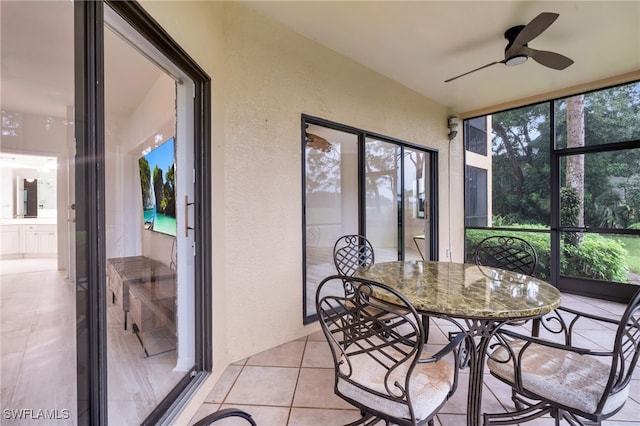 sunroom featuring ceiling fan