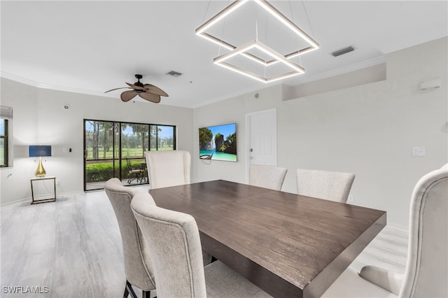 dining room with ornamental molding, light wood-type flooring, and ceiling fan