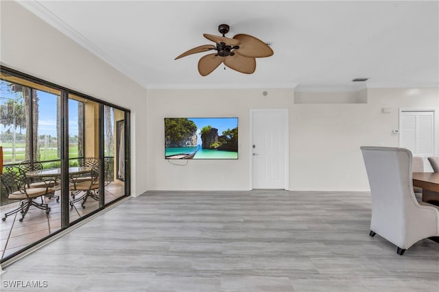 unfurnished living room featuring crown molding and ceiling fan