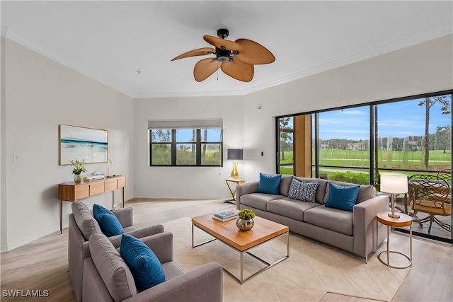 living room with light hardwood / wood-style floors, crown molding, and ceiling fan