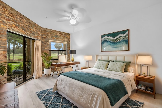 bedroom featuring ceiling fan, light hardwood / wood-style flooring, and access to exterior