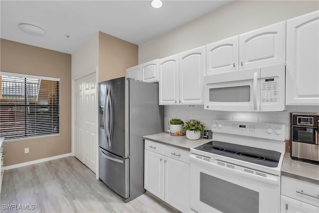 kitchen featuring light hardwood / wood-style floors, white cabinetry, white appliances, and tasteful backsplash