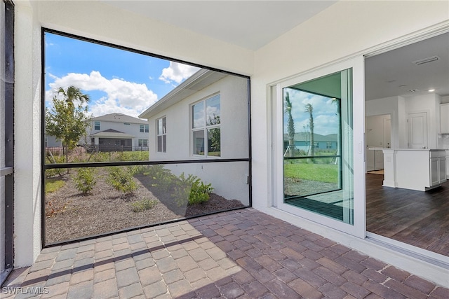 unfurnished sunroom featuring a healthy amount of sunlight