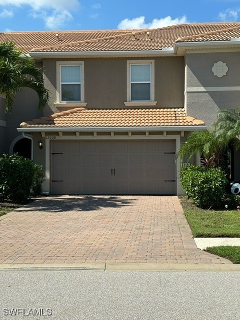 mediterranean / spanish-style home featuring a garage