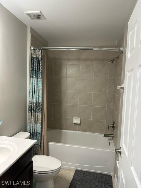 full bathroom featuring tile patterned flooring, vanity, toilet, and shower / tub combo