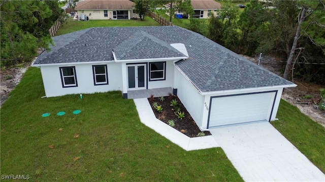 single story home featuring a garage and a front yard