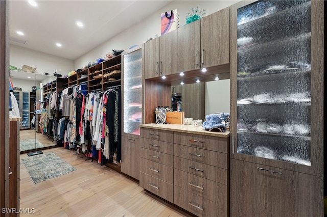 walk in closet featuring light hardwood / wood-style flooring