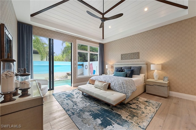 bedroom featuring access to outside, ceiling fan, light hardwood / wood-style flooring, and wooden ceiling