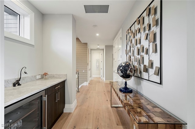 hall featuring light hardwood / wood-style floors and beverage cooler