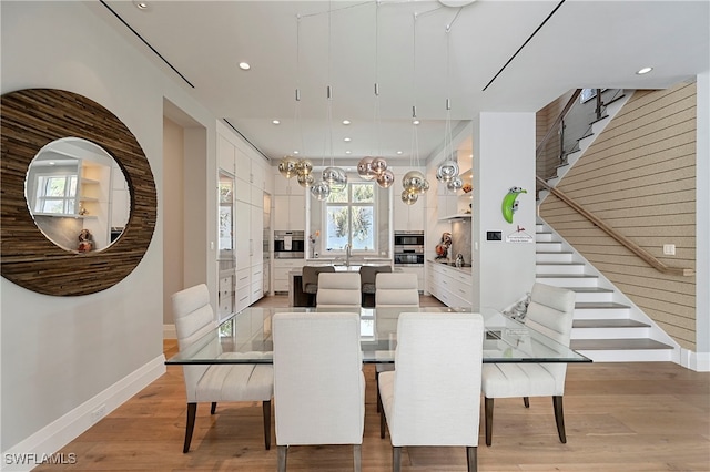 dining room with sink and light hardwood / wood-style floors