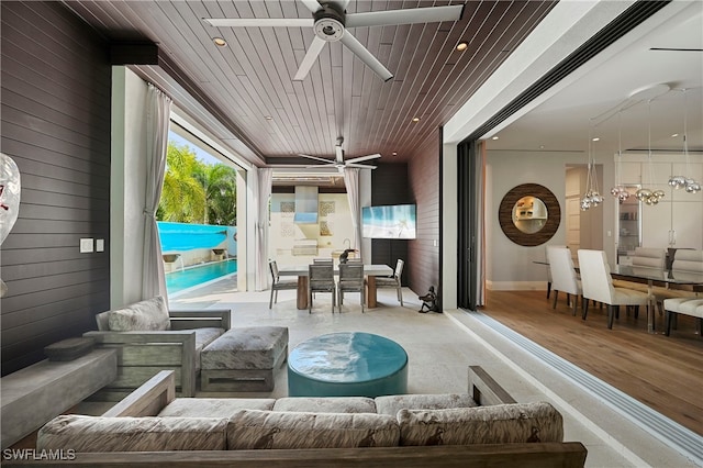 sunroom / solarium featuring ceiling fan and wood ceiling