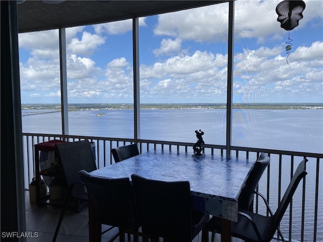 sunroom / solarium with a wealth of natural light and a water view