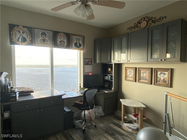 office space with built in desk, dark hardwood / wood-style floors, and ceiling fan